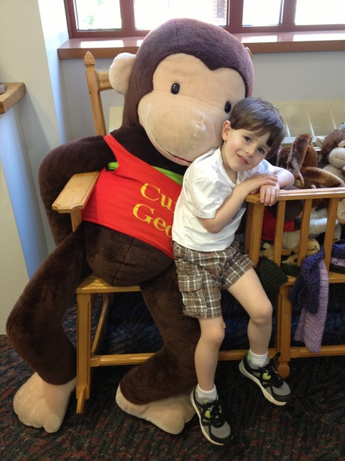 Decker with Curious George at the library